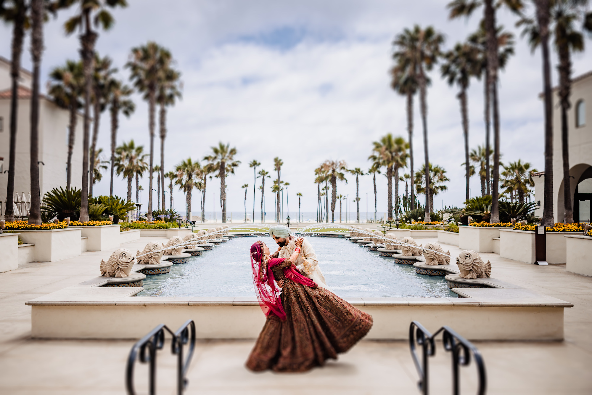 Indian wedding portrait by the 16 Fish Fountain at the Hyatt Regency Huntington Beach photographed by Lin and Jirsa