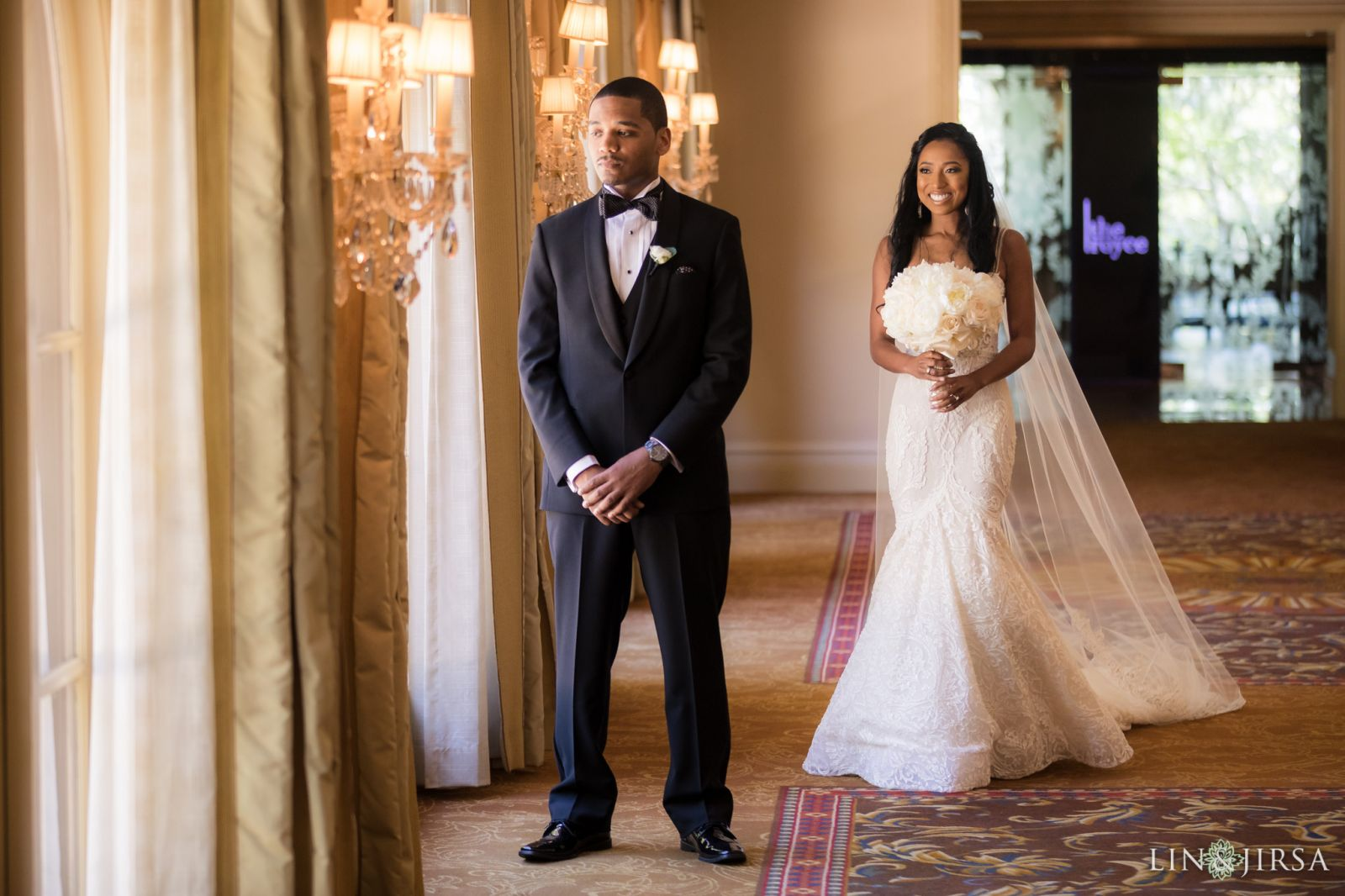 Couple first look in the hallway at Langham Huntington Pasadena wedding photographed by Lin and Jirsa
